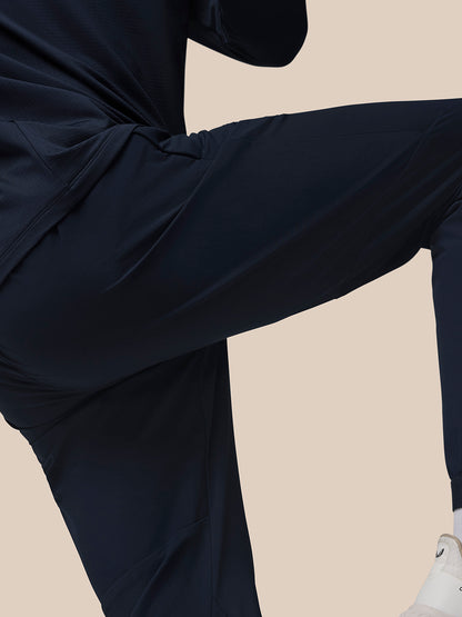 Side view of navy Flow Training Joggers with panelled silhouette and ergonomic seam lines