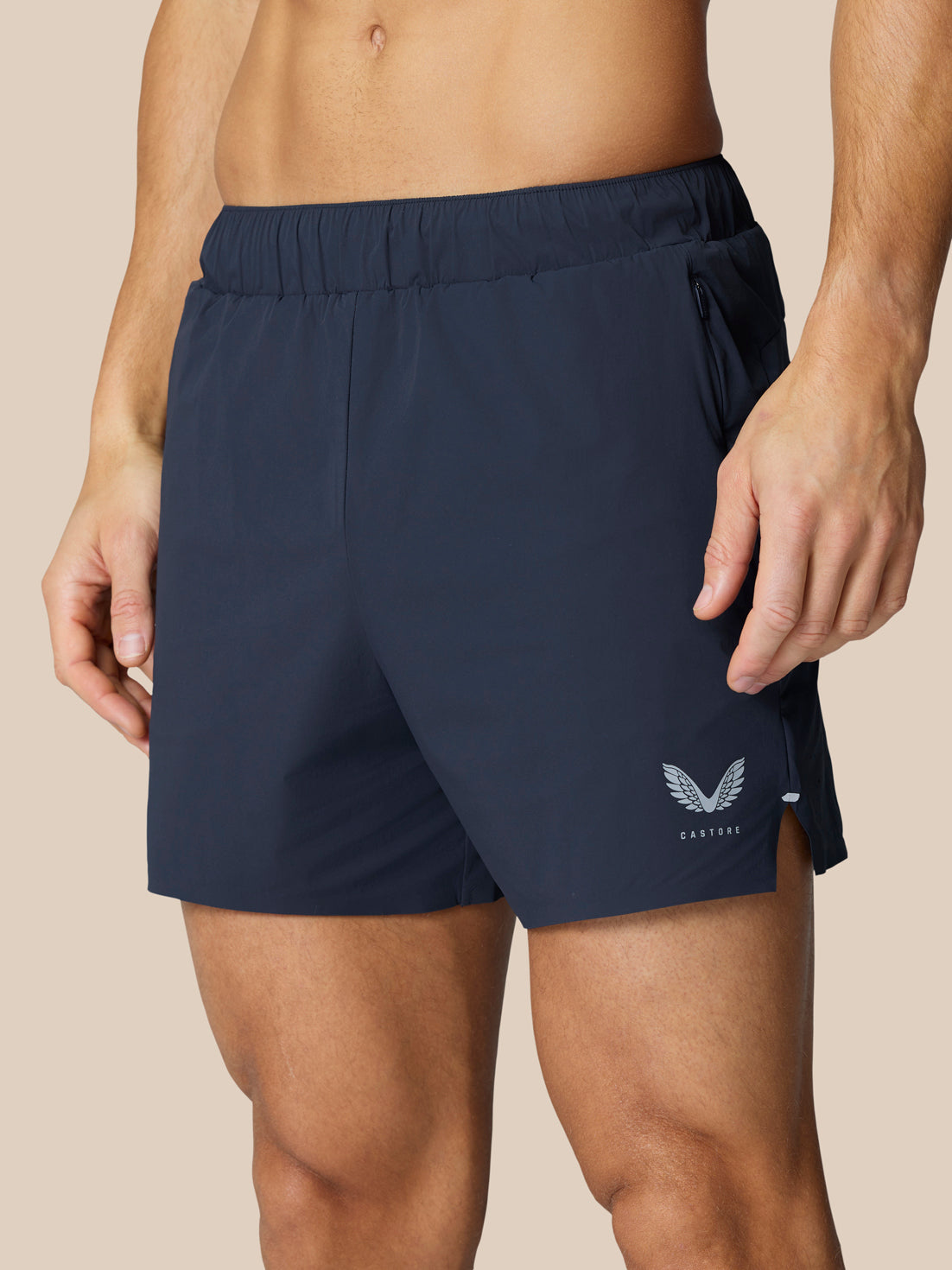 Navy Zone Training Shorts shown with zip pocket and reflective logo on left thigh