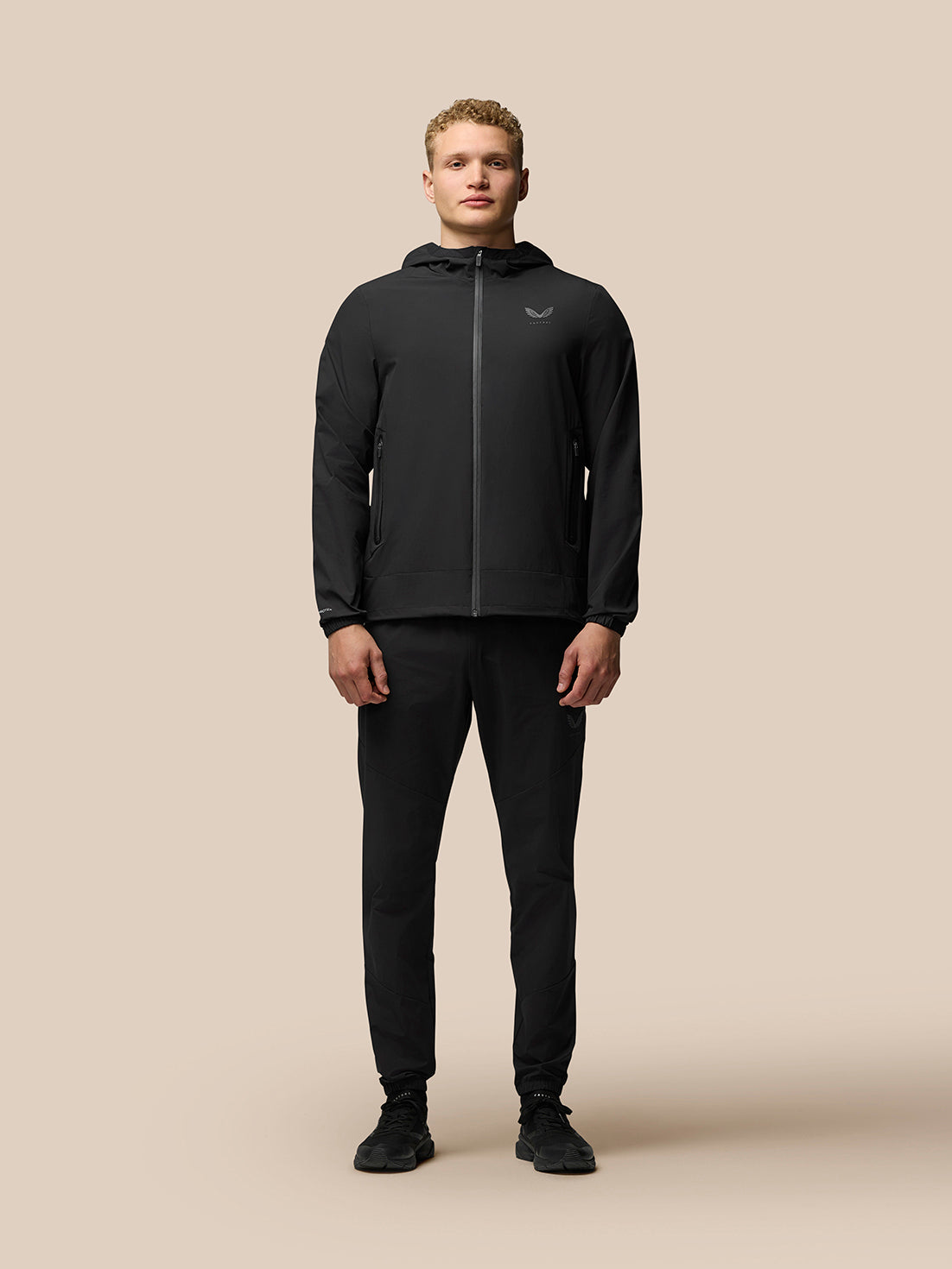 Male model in black Flex lightweight joggers with an elastic waistband and zip pockets