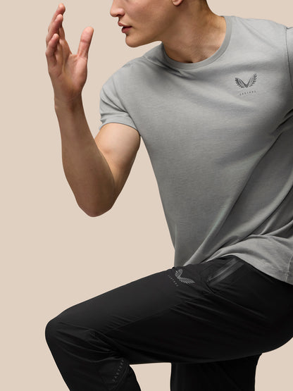 Side view of a man in black Flex Lightweight Joggers with a side zip pocket and Castore logo on the left leg