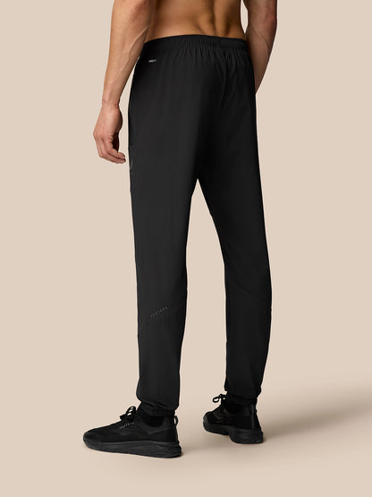 Back view of black Flex Classic Lifestyle Joggers on a model, displaying ProTek water resistance and Castore logo on the left leg