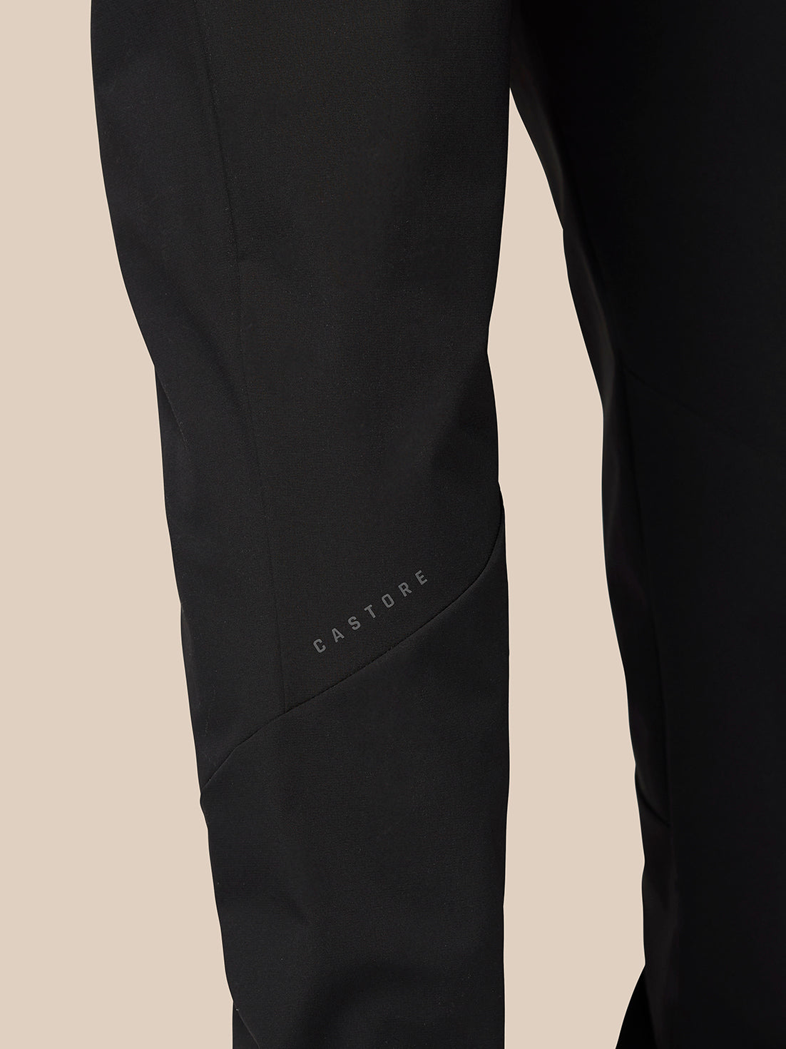 Close-up of the lower leg of black Flex Classic Lifestyle Joggers showing the Castore logo and curved seam detailing