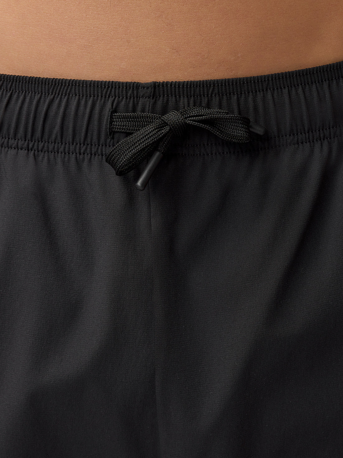 Close-up of the black joggers waistband with a tied drawcord