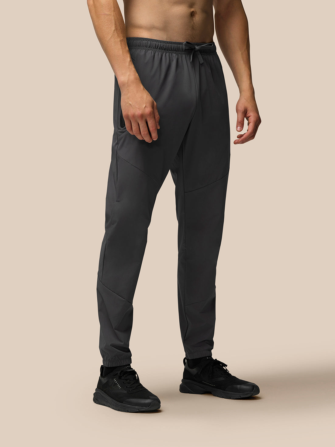 Lower body view of grey Flex joggers with zip pockets and drawstring waistband.