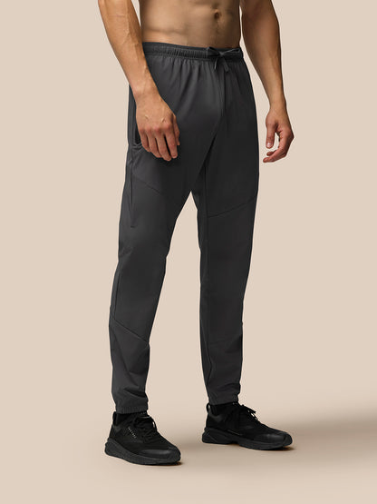 Lower body view of grey Flex joggers with zip pockets and drawstring waistband.