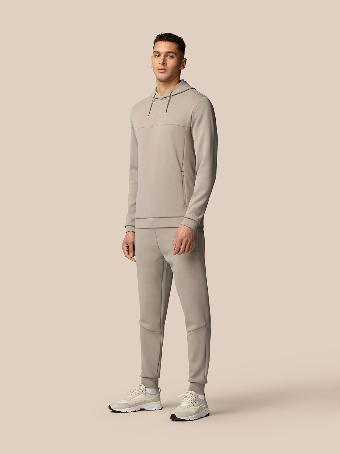 Full-length shot of a male model wearing Rock Grey Flex Lifestyle Joggers with a matching hoodie