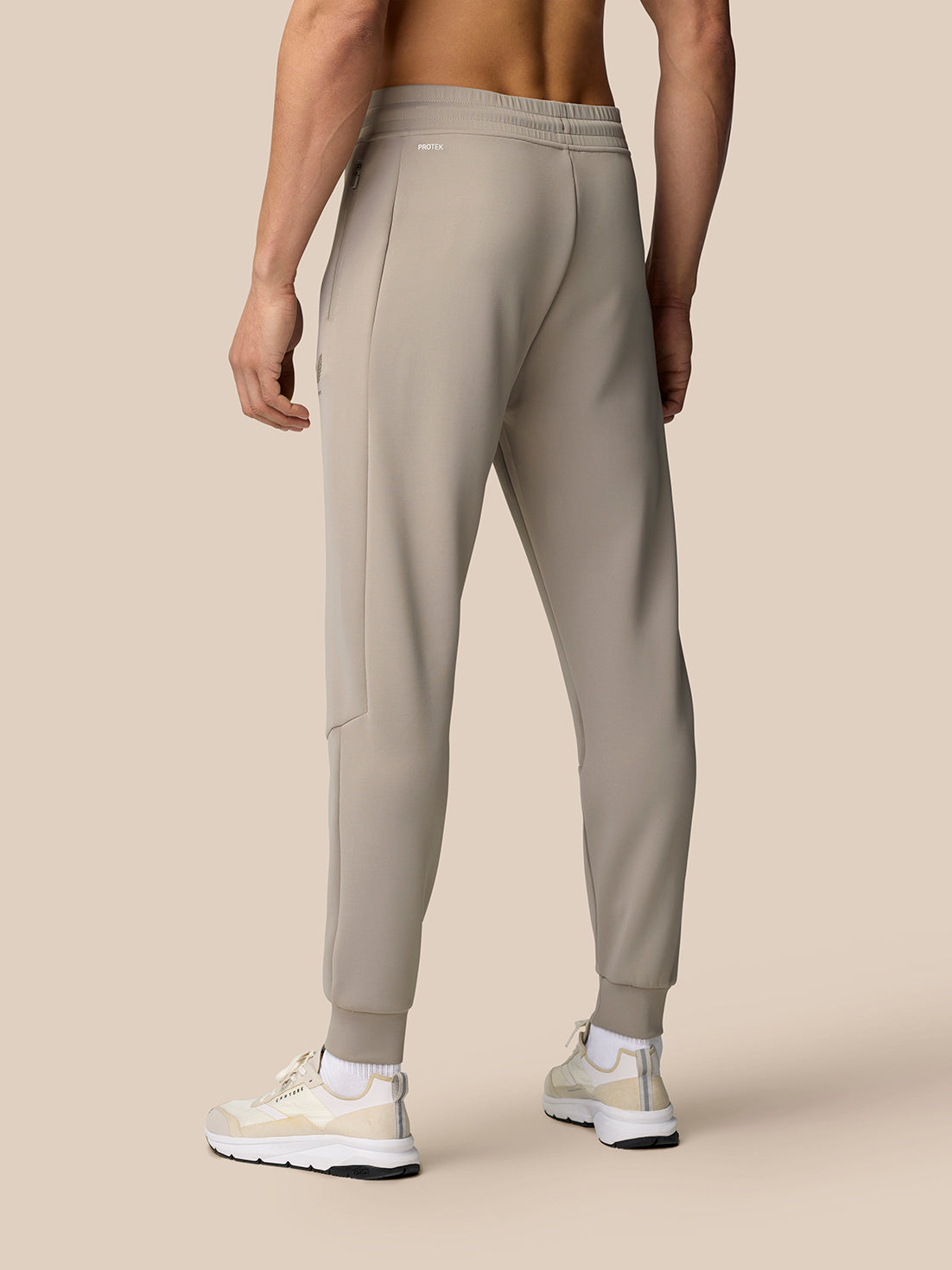 Rear view of Rock Grey Flex Lifestyle Joggers showing hip zip pocket and Castore logo on the thigh