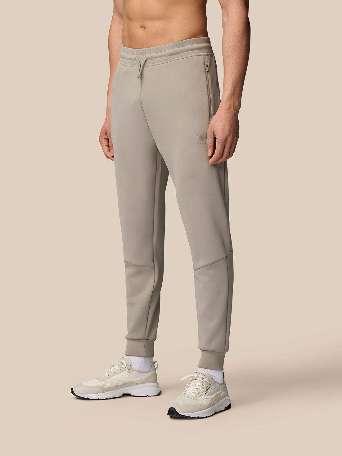 Front view of a model wearing Rock Grey Flex Lifestyle Joggers with drawstring waist cuffed ankles and waterproof zip pockets