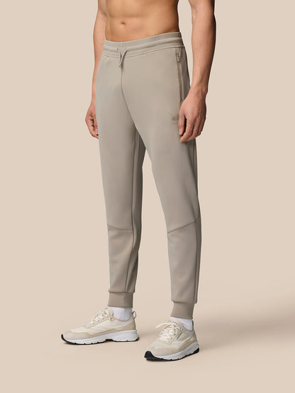Front view of a model wearing Rock Grey Flex Lifestyle Joggers with drawstring waist cuffed ankles and waterproof zip pockets