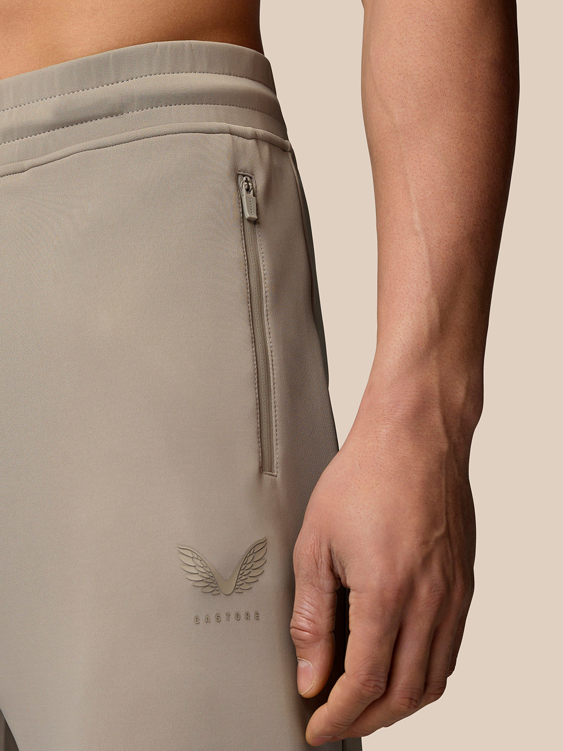 Close up of hip area of Rock Grey Flex Lifestyle Joggers highlighting the back zipper pocket and Castore logo