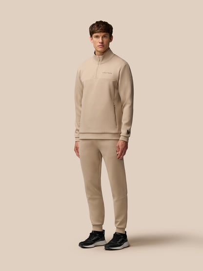 Male model wearing Mushroom Flex Lifestyle Joggers with matching top and black sneakers.