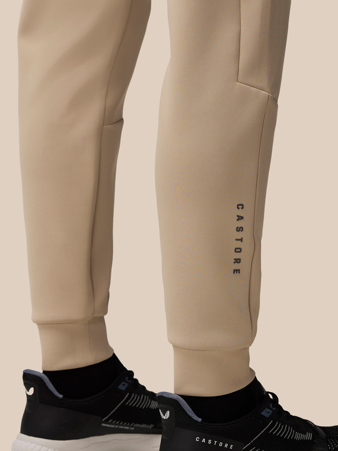 Mushroom Flex Scuba Joggers leg close up showing Castore wordmark along the lower calf.