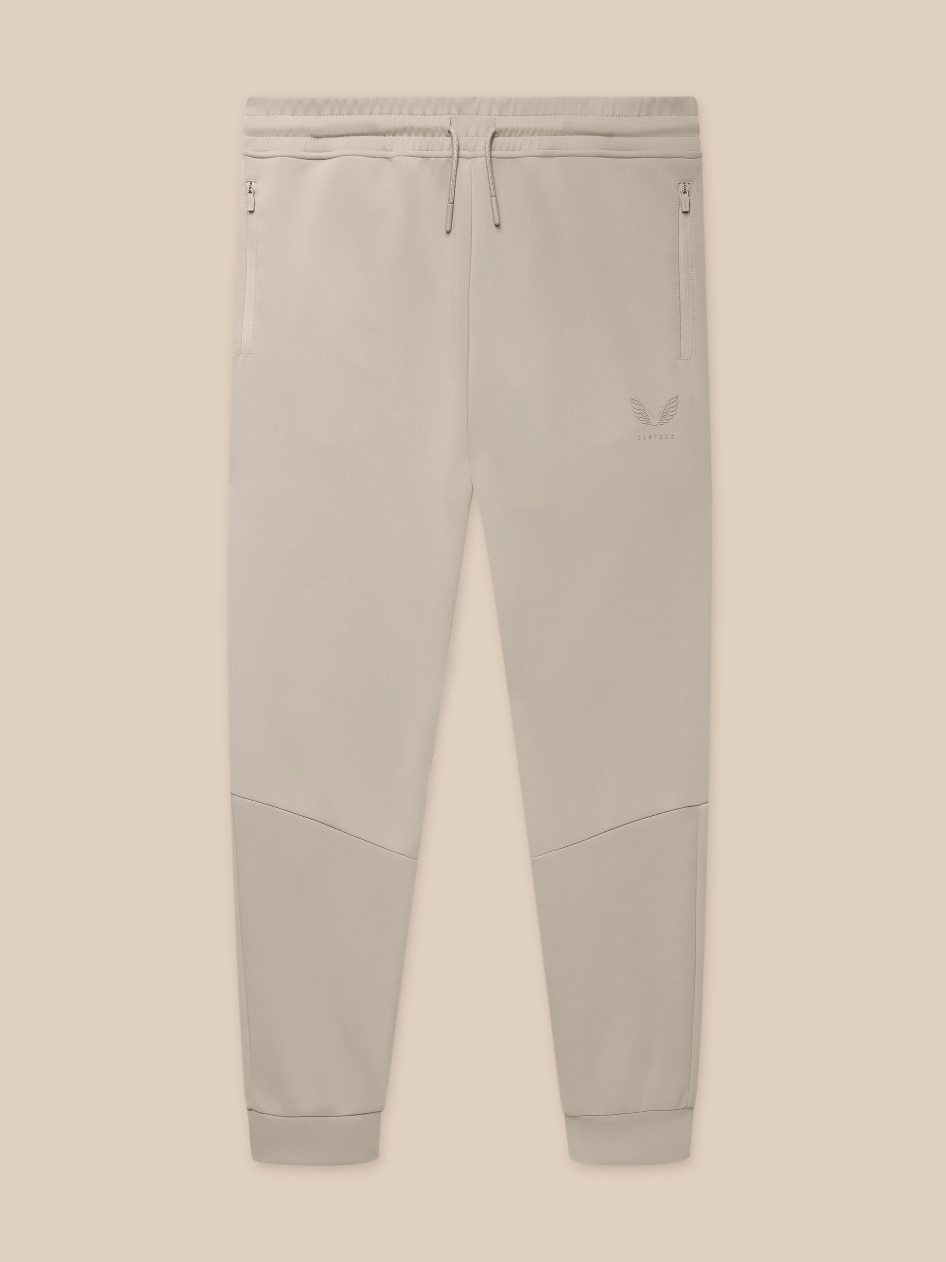Close-up of waistband with drawcords and zip pockets on Rock Grey joggers with logo on the thigh