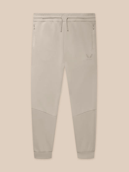 Close-up of waistband with drawcords and zip pockets on Rock Grey joggers with logo on the thigh