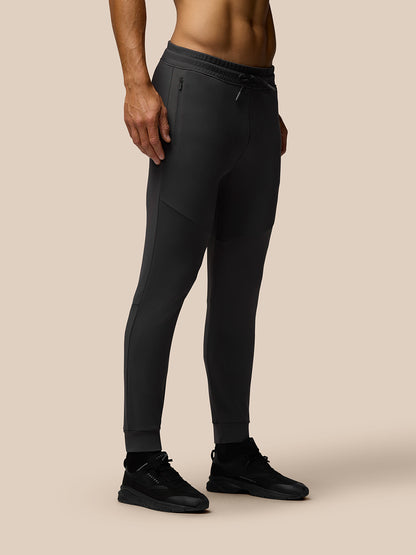 Model wearing charcoal Flex Thermo Joggers with panel detailing and black sneakers