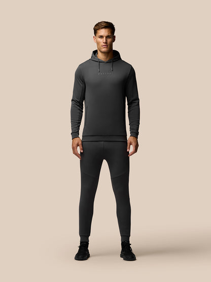 Male model in Charcoal Flex Thermo Joggers and hoodie with CASTORE logo on the chest.