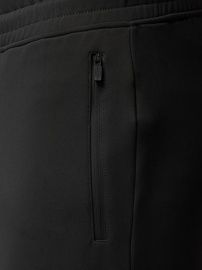 Full-body shot of male model wearing Charcoal Flex Thermo Joggers with a matching top.