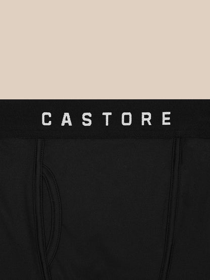Close-up of black Castore boxer waistband with white CASTORE logo on a beige background