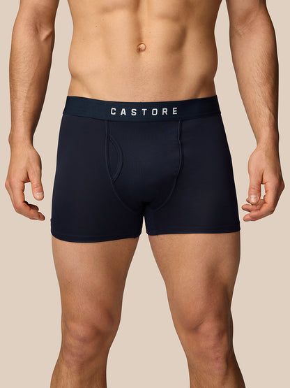 Back view of a man wearing navy boxer shorts with a CASTORE waistband