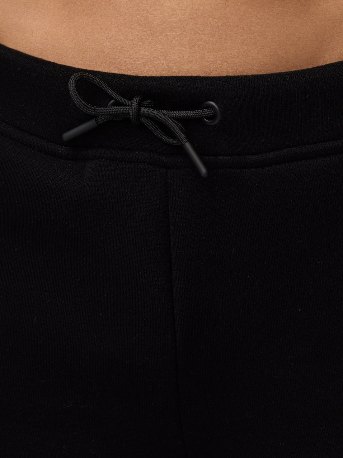 Close-up of waistband with drawcord on black Adapt Fleece Joggers