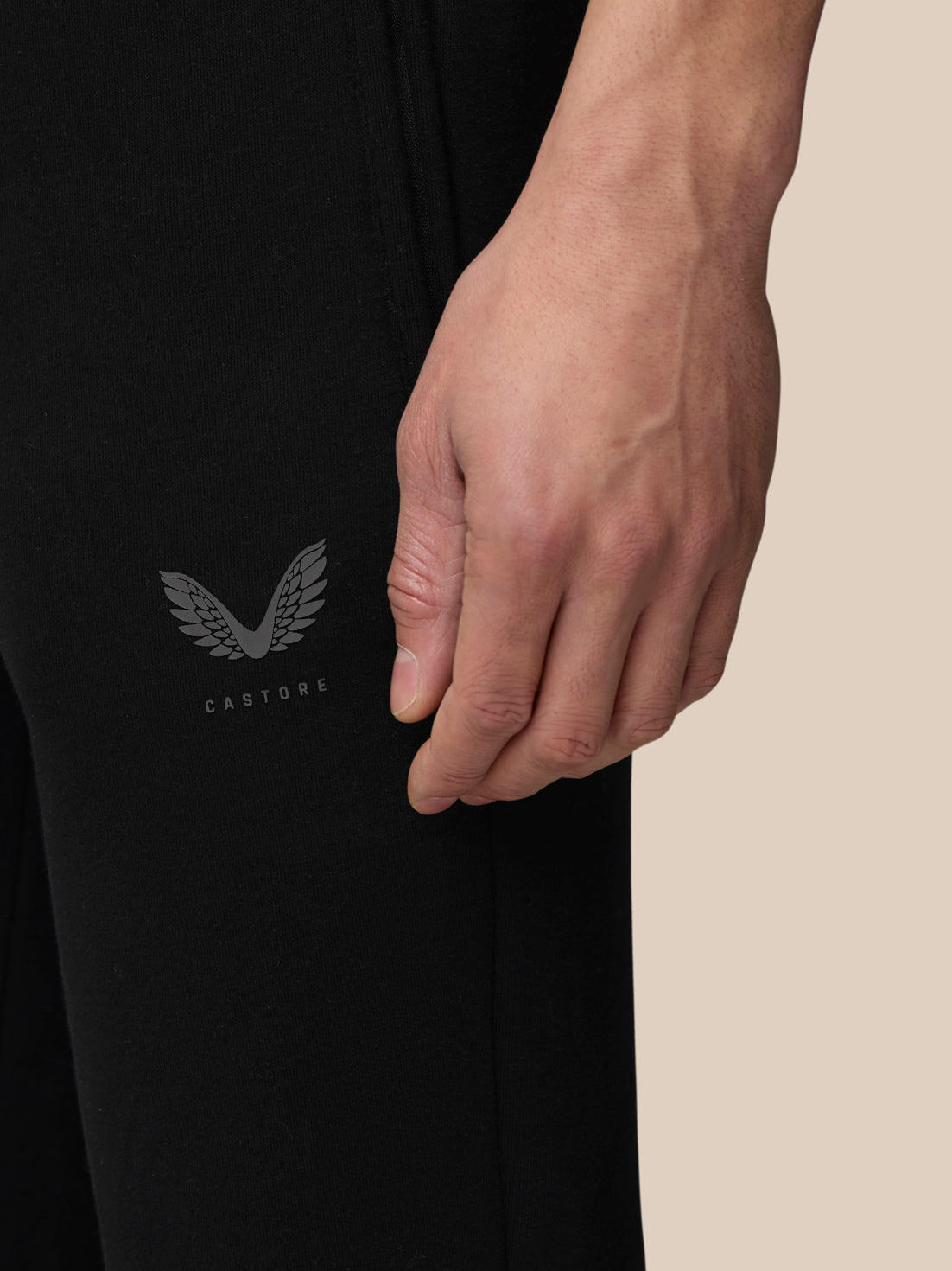 Side view of black Adapt Fleece Joggers with Castore logo on the thigh