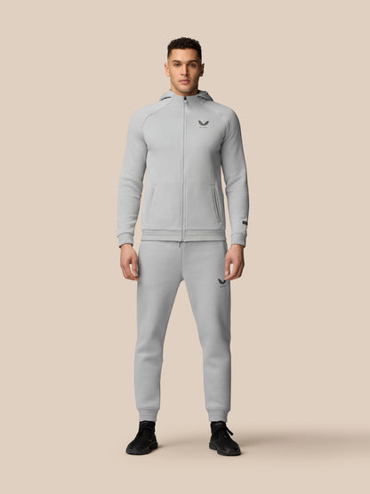 Male model wearing grey Adapt Fleece joggers with zip pockets and drawstring waist