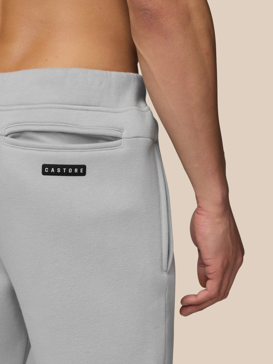 Close-up of back pocket area with Castore label on grey Joggers.