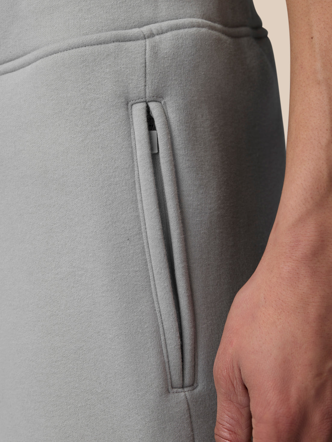 Close-up of side zip pocket on grey Adapt Fleece Joggers.