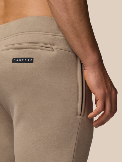Beige Adapt Fleece joggers back pocket detail with Castore label