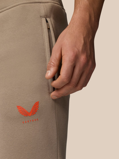 Side view of Adapt Fleece Joggers with a secure zip pocket and an orange Castore emblem on the leg.