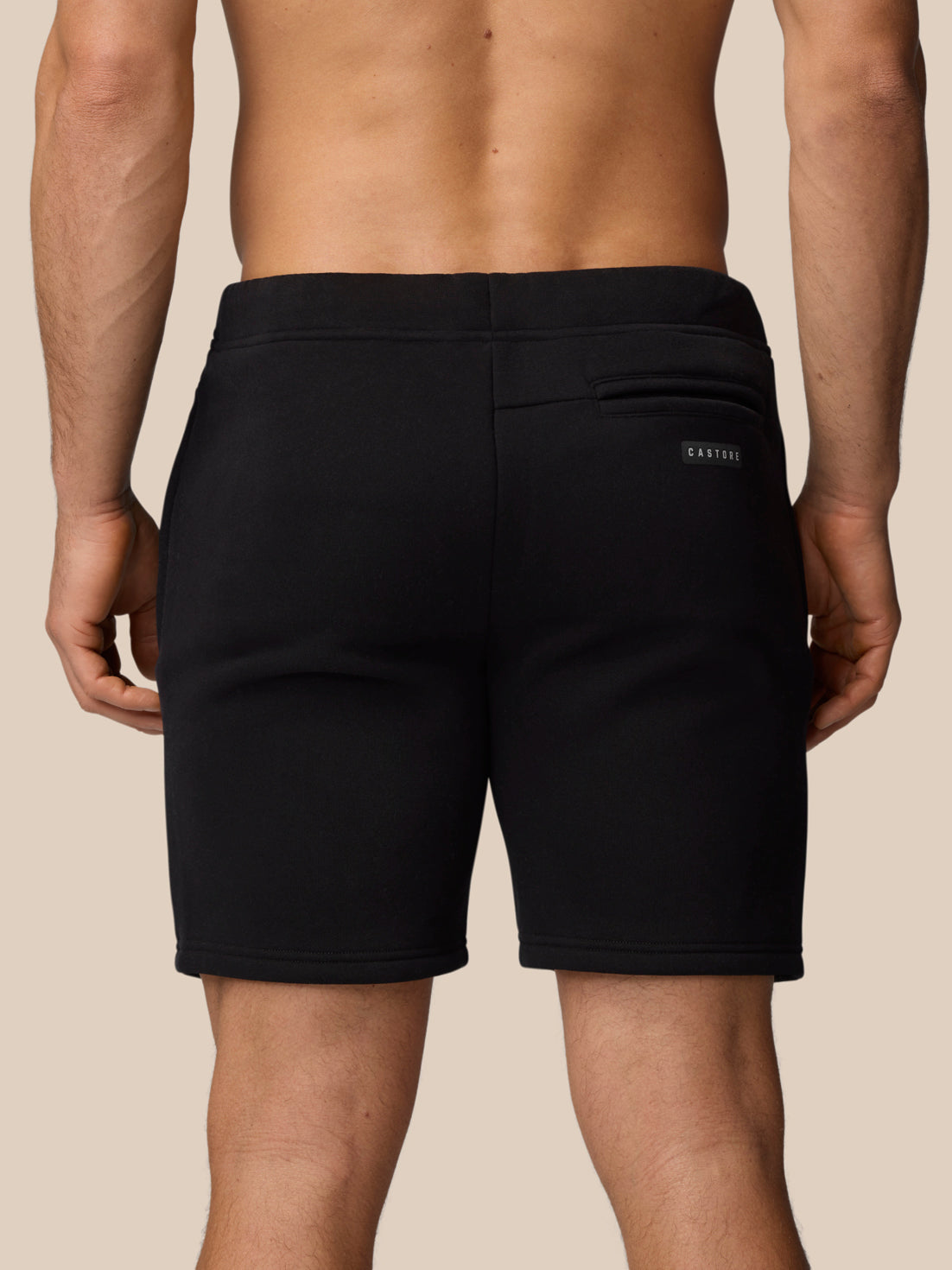 Back view of black Adapt Fleece Jogger Shorts with a rear pocket and small Castore logo