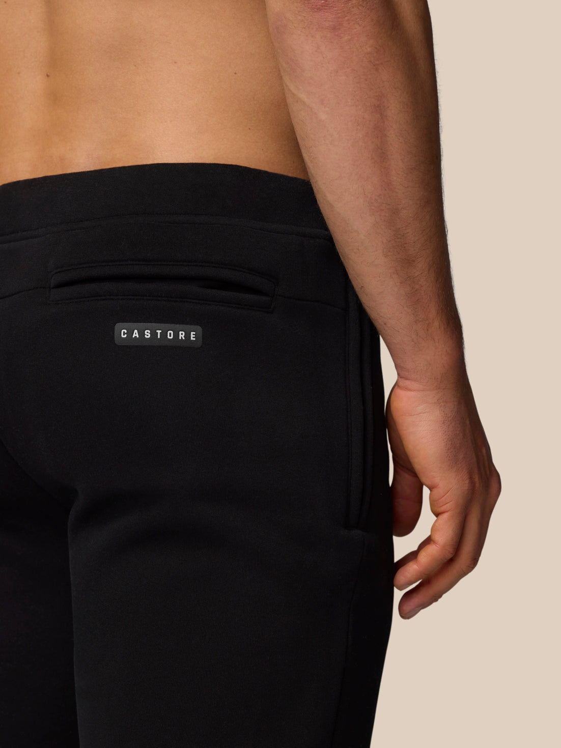 Back view of black Adapt Fleece Jogger Shorts with a rear welt pocket and Castore logo