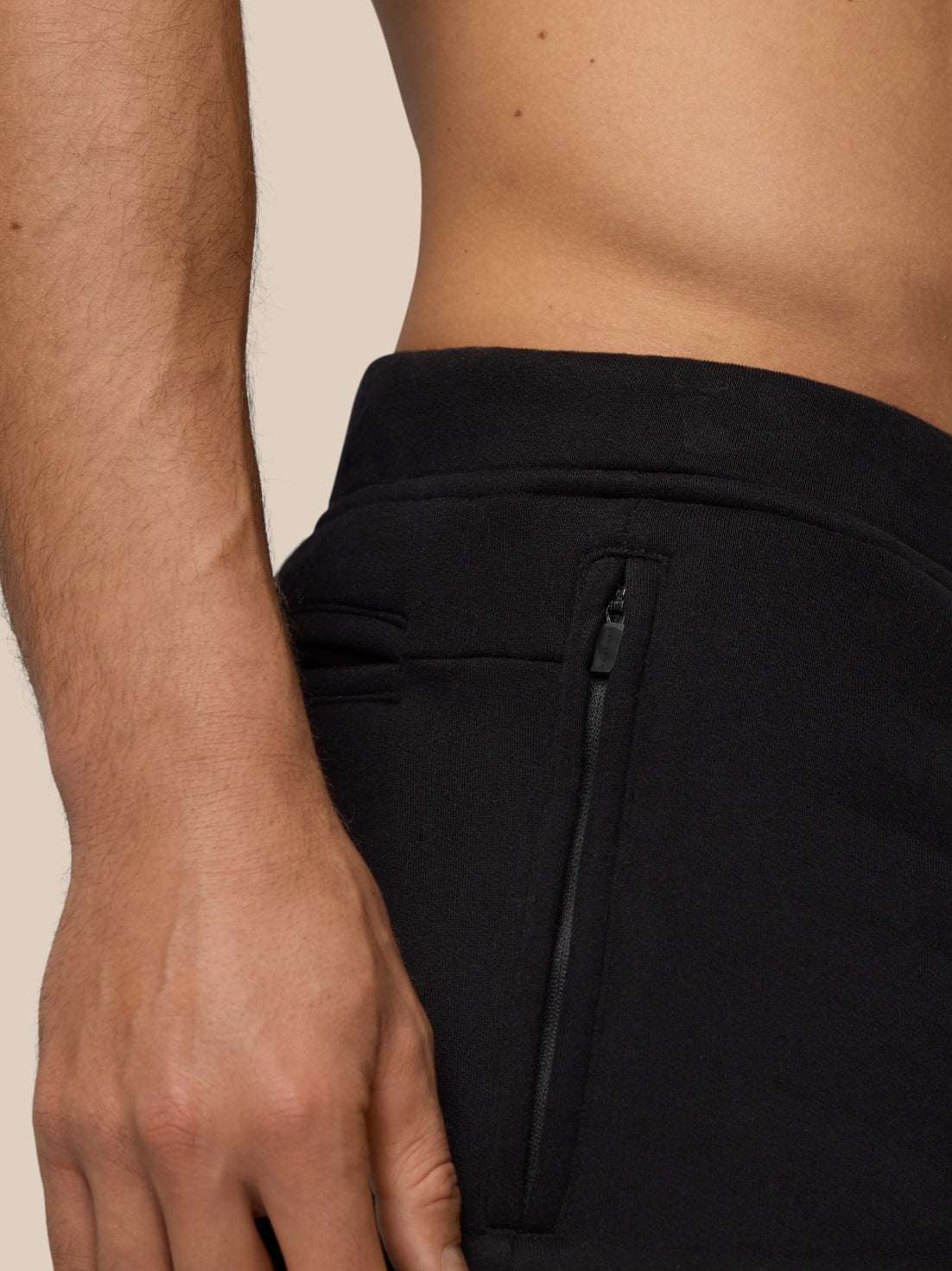 Close up of side zip pocket on black Adapt Fleece Jogger Shorts