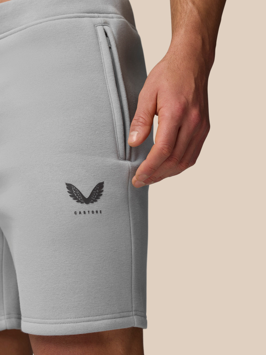 Close up of Adapt Fleece Jogger Shorts in grey showing a zip pocket and Castore logo