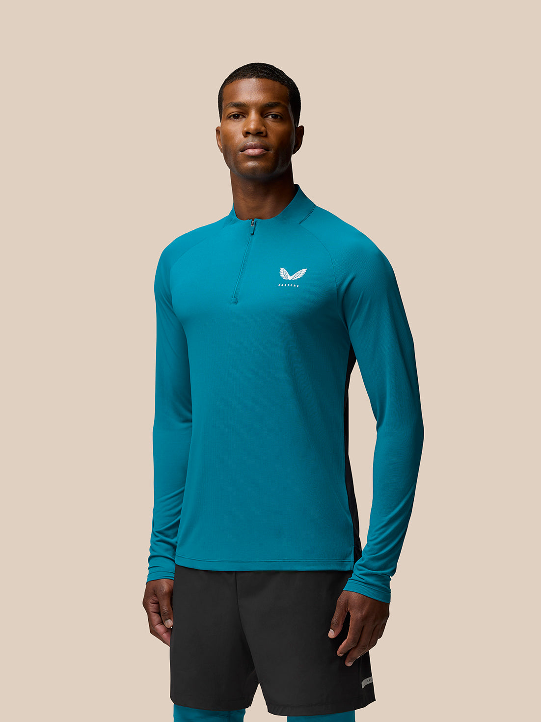 Flow Training 1/4 Zip Top in dark aqua with black side panels and a front quarter-zip.