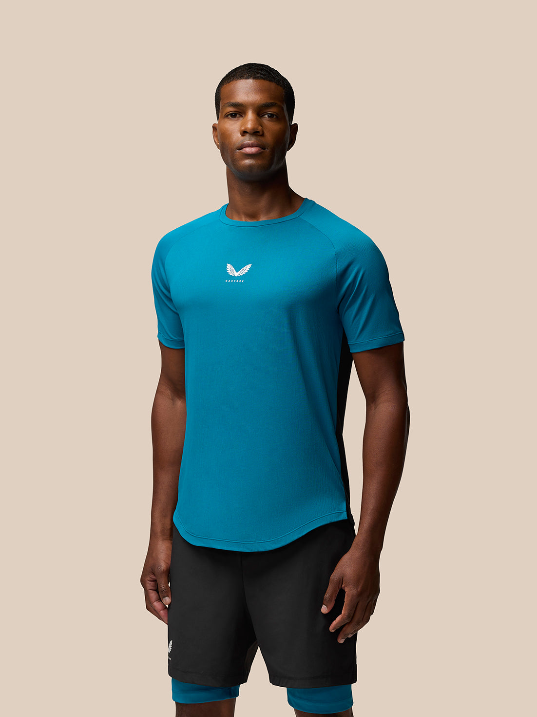 Male model wearing Flow Training T-Shirt in Dark Aqua front view with Castore logo on the chest