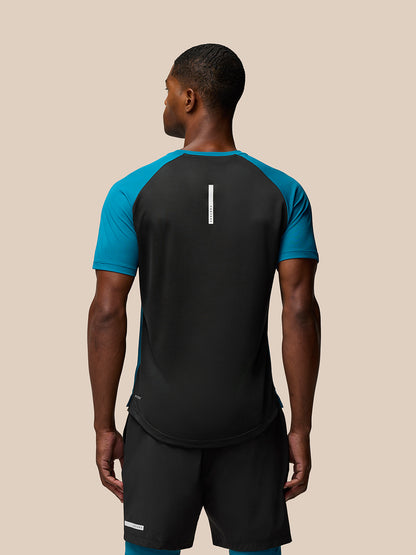 Back view of Flow Training T-Shirt Dark Aqua on a male model showing center back branding