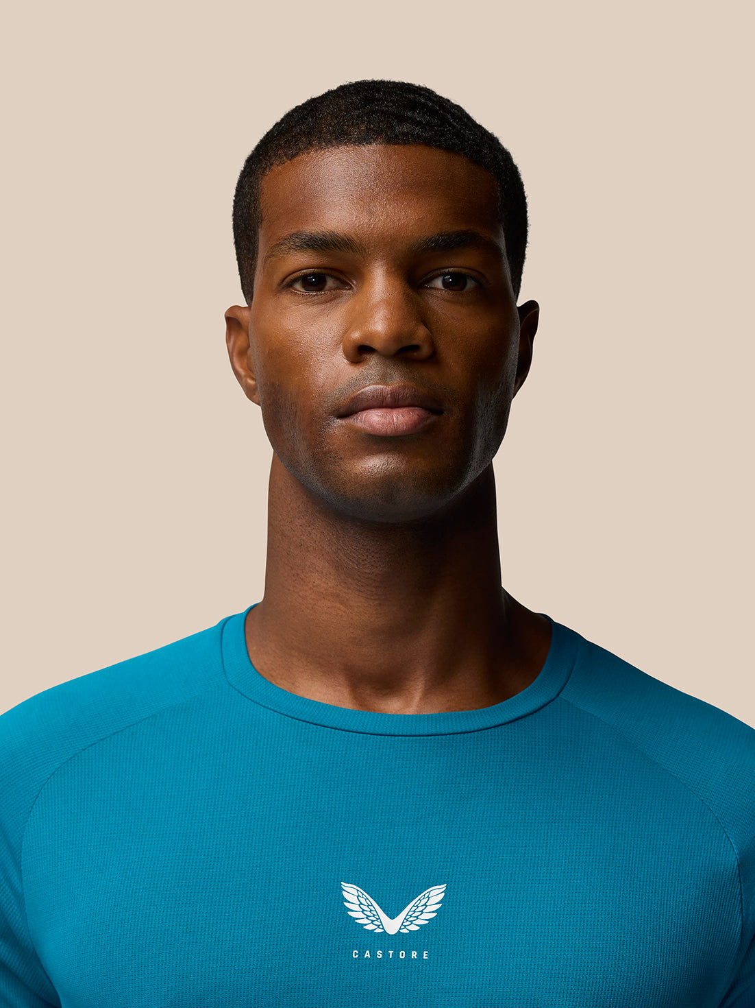 Rear close up of Flow Training T-Shirt Dark Aqua showing teal sleeves and back branding