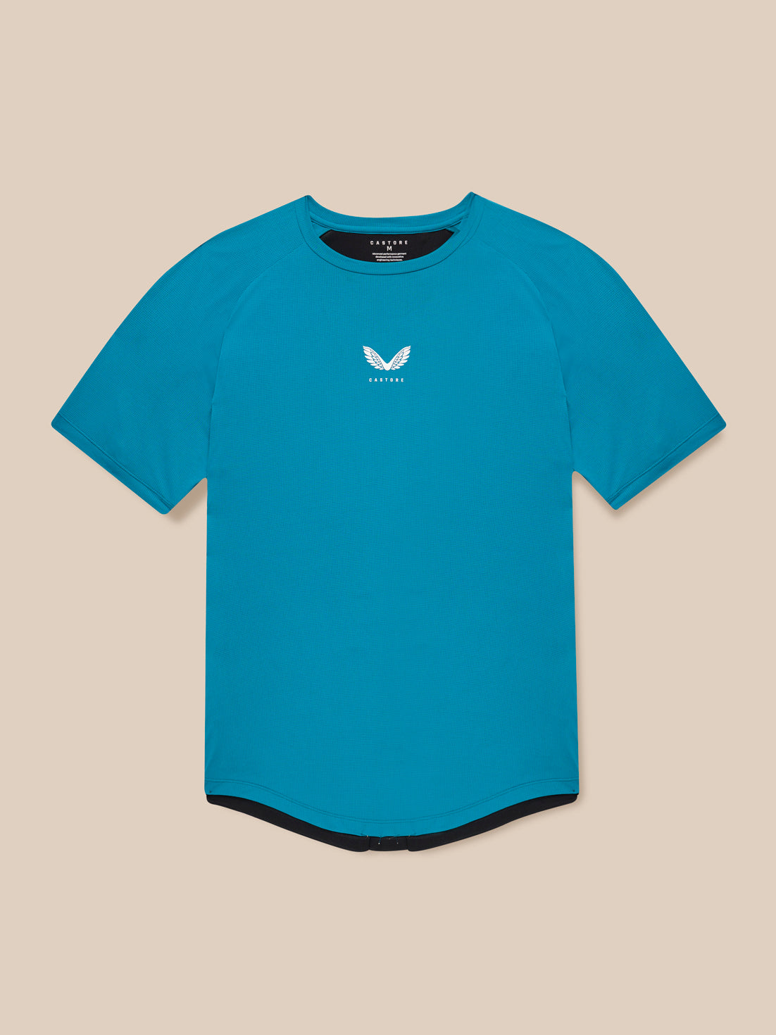 Male model wearing Flow Training T-Shirt in dark aqua with center chest logo front view against beige backdrop