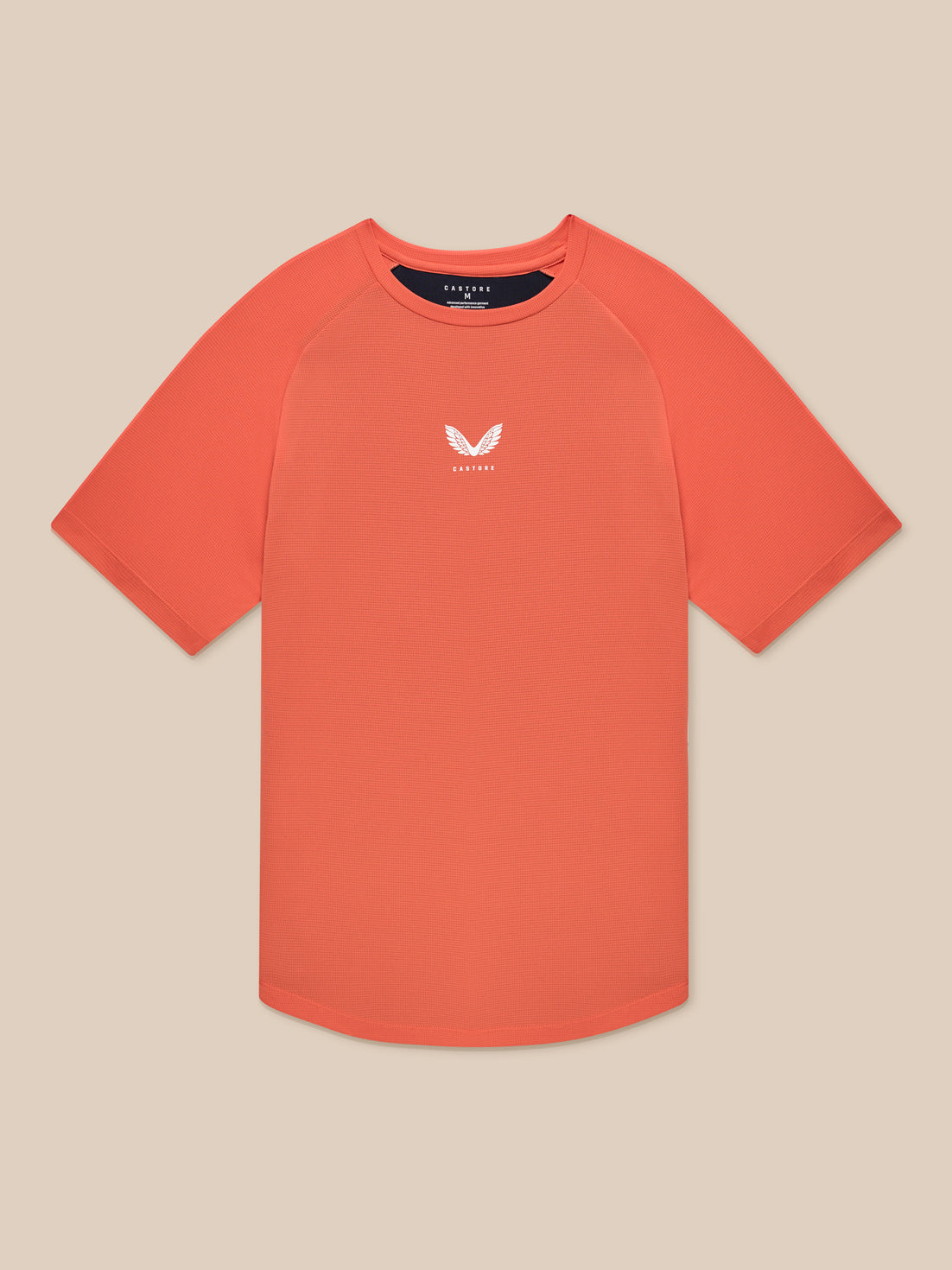 Flat lay of orange breathable gym T shirt with small white logo on the chest