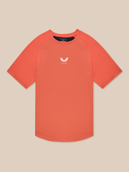 Flat lay of orange breathable gym T shirt with small white logo on the chest
