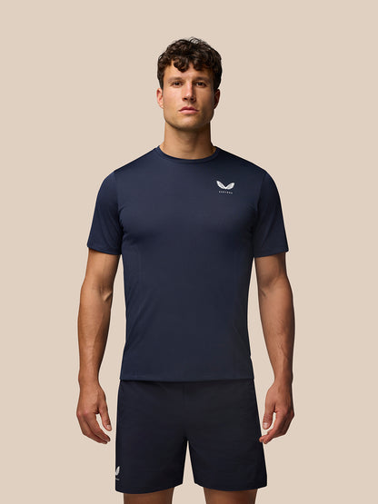 Male model wearing midnight navy Apex Training T-Shirt with crew neck raglan sleeves and Castore branding on the chest