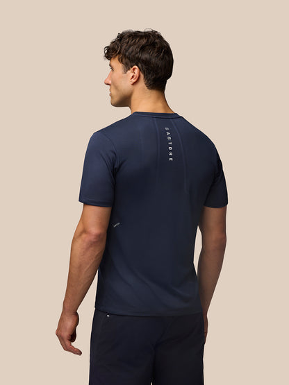 Back view of a man in Midnight Navy Apex Training T Shirt, showing vertical Castore branding along the upper back