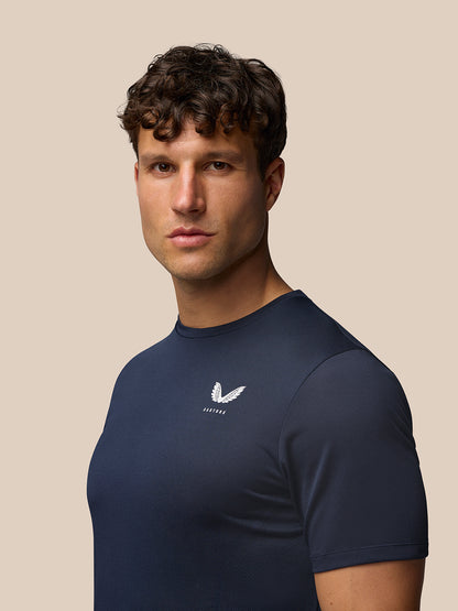 Front three quarter view of a man wearing Midnight Navy Apex Training T Shirt with Castore logo on chest