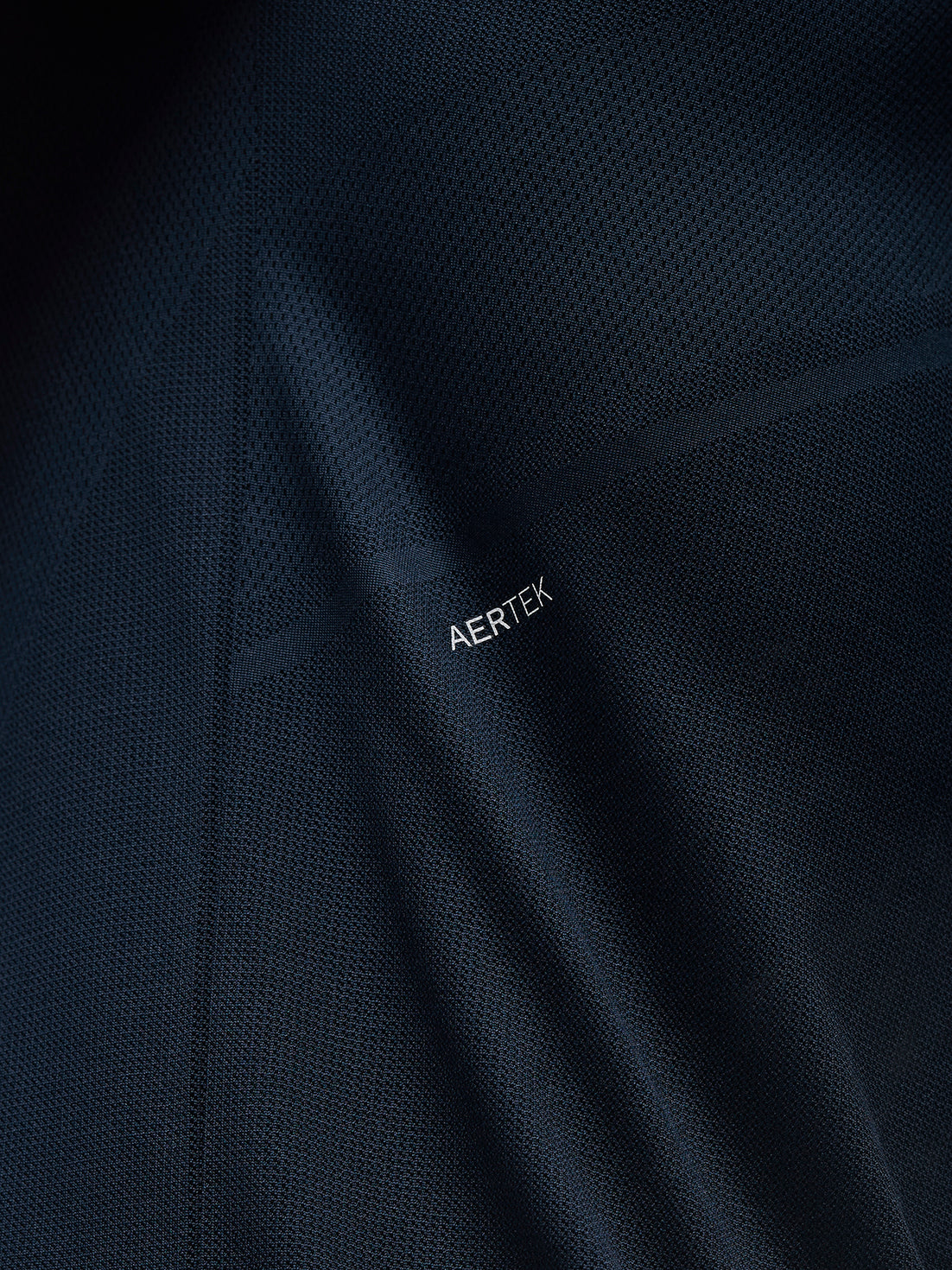 Close up of navy Apex Training T Shirt fabric with AERTEK branding on the back panel