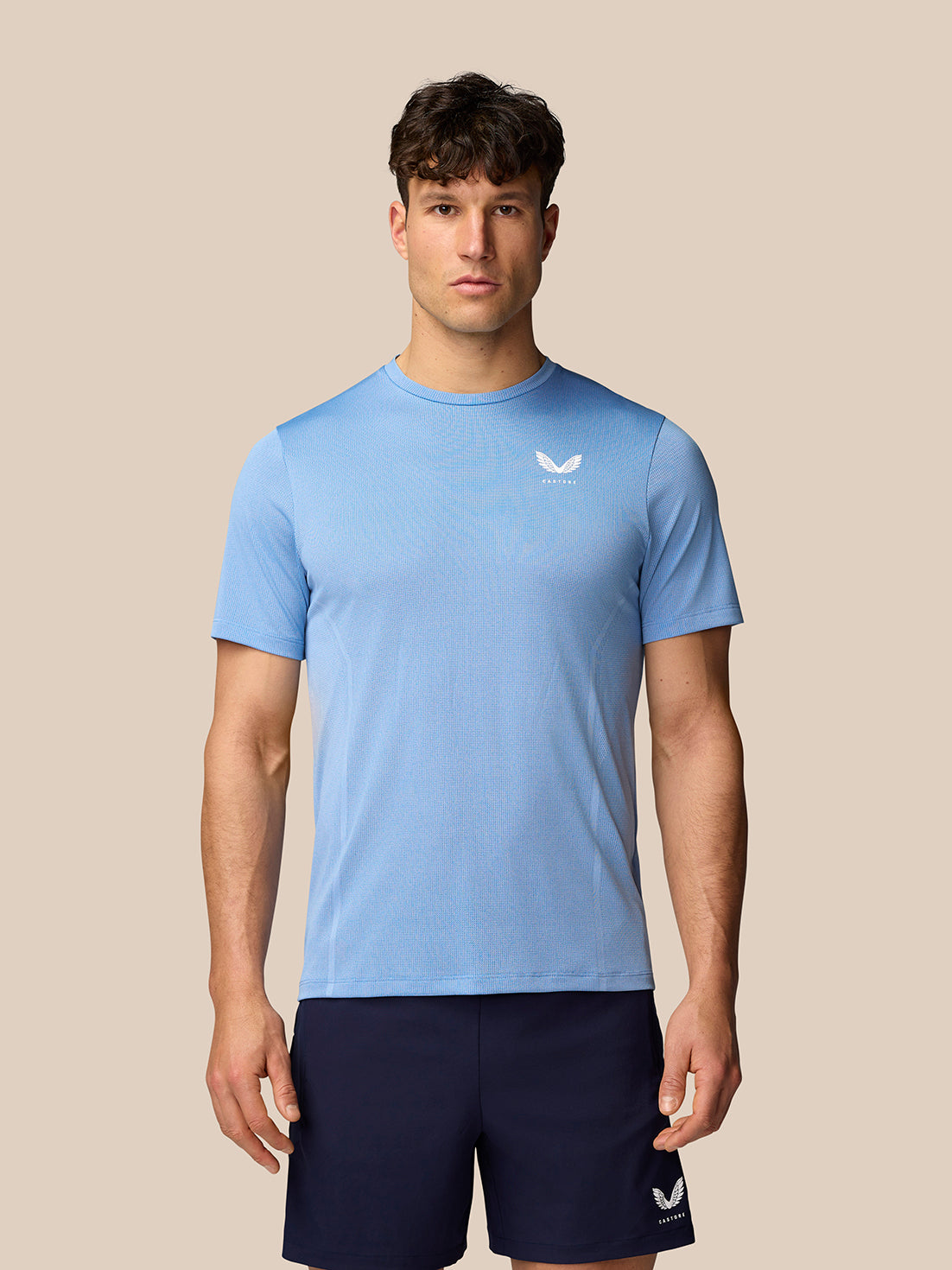 Man wearing sky blue Apex Training T-Shirt with crew neck and breathable mesh knit