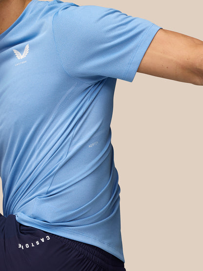 Side view of sky blue Apex Training T-Shirt highlighting mesh texture and Aertek label along the side.