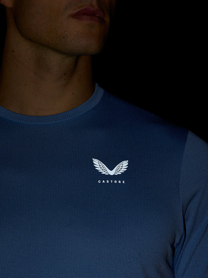 Close-up of blue Apex Training T-Shirt showing white crest logo on chest.
