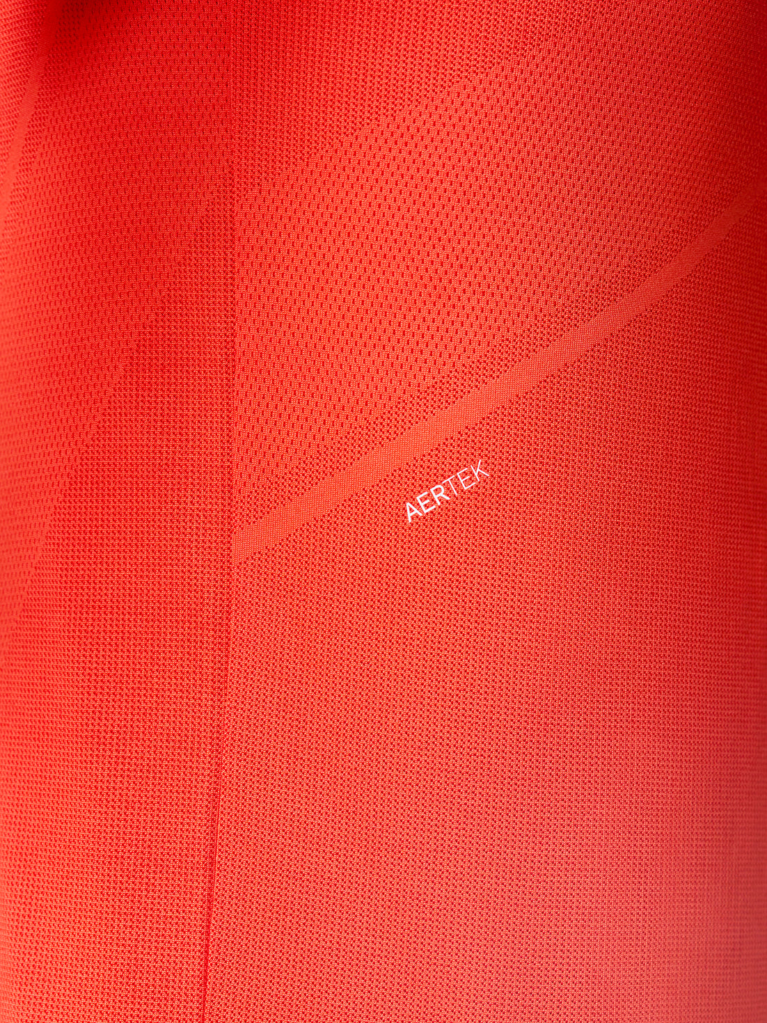 Close-up of red Apex Training T Shirt fabric with Aertek branding along a back seam