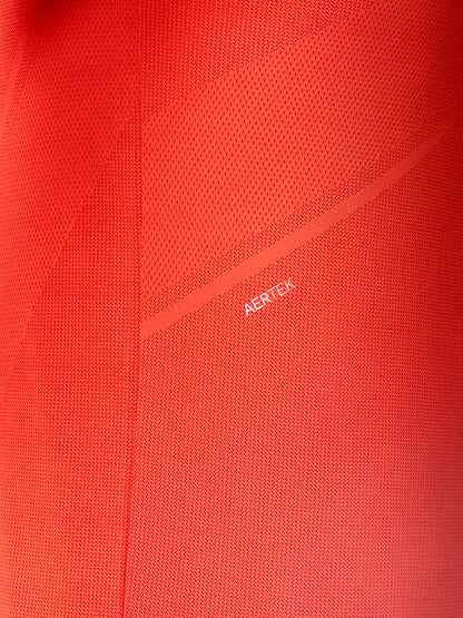 Close-up of red Apex Training T Shirt fabric with Aertek branding along a back seam